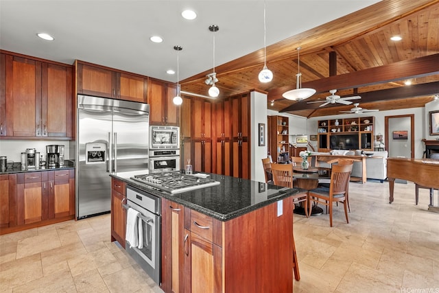 314 Lapa Pl, Kailua, HI 96734 - kitchen with built in appliances, open floor plan, a ceiling fan, brown cabinetry, and dark stone countertops