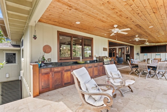 exterior space featuring exterior kitchen, a grill, and ceiling fan