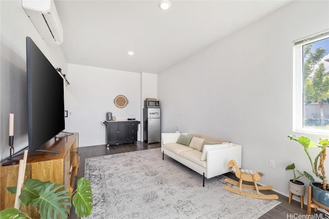 living area featuring an AC wall unit, recessed lighting, and dark wood-type flooring