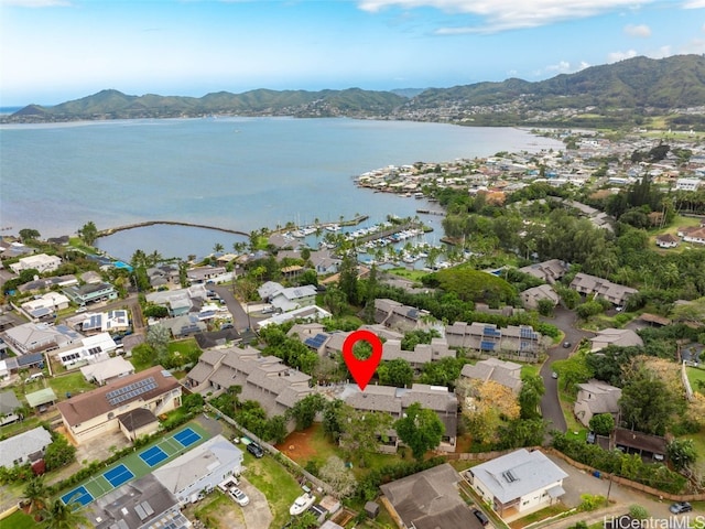 drone / aerial view featuring a water and mountain view