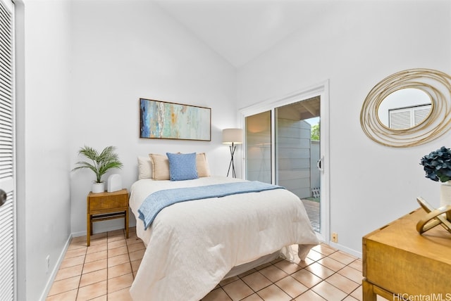 bedroom with light tile patterned floors, baseboards, lofted ceiling, and access to outside