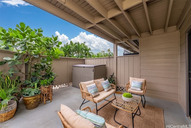 view of patio with an outdoor living space and fence