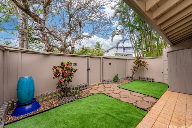 view of yard featuring a patio, a fenced backyard, and a gate