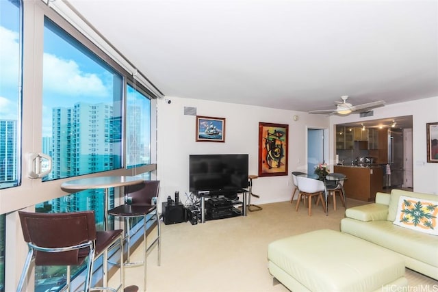 carpeted living room featuring ceiling fan