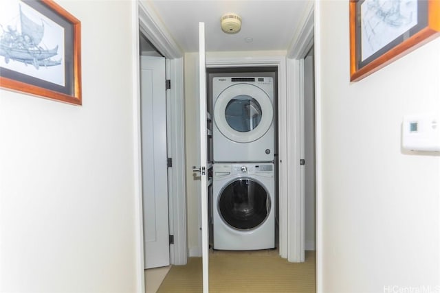 laundry area featuring stacked washer and dryer