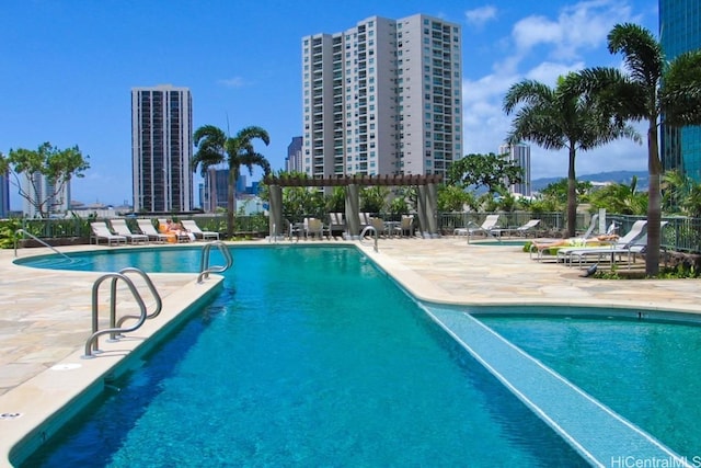 view of pool with a pergola and a patio