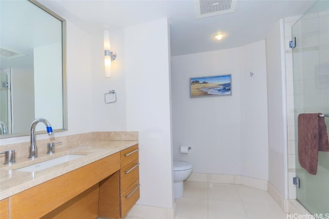 bathroom featuring vanity, tile patterned floors, toilet, and walk in shower