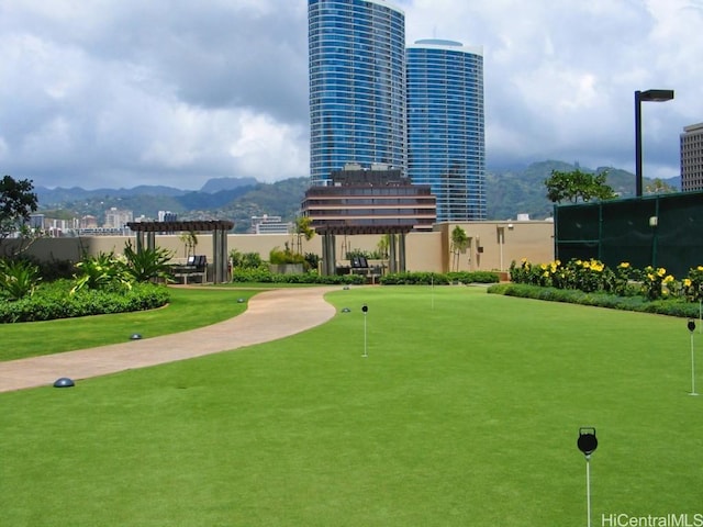 view of community with a mountain view and a pergola