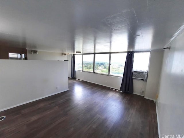 unfurnished room with cooling unit and dark hardwood / wood-style floors