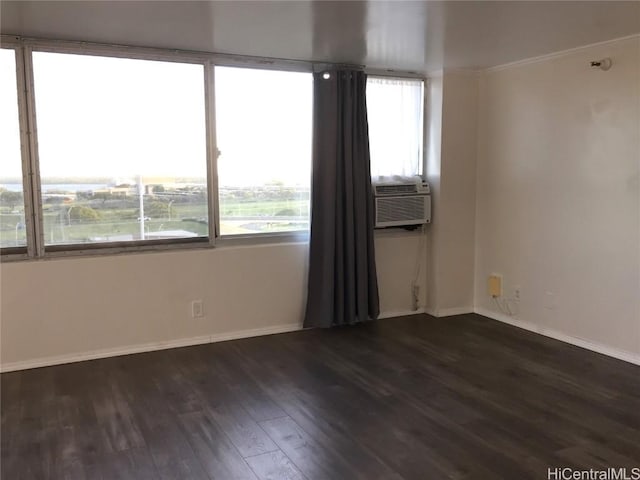 empty room with cooling unit, dark wood-type flooring, and a water view