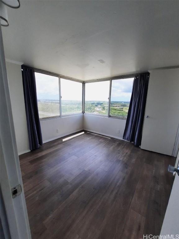 unfurnished room featuring dark hardwood / wood-style floors