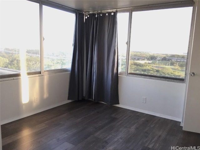 unfurnished room featuring dark hardwood / wood-style flooring