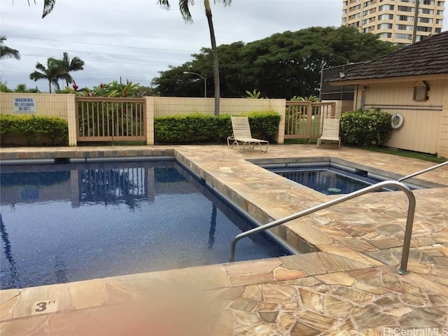 view of pool featuring a hot tub and a patio