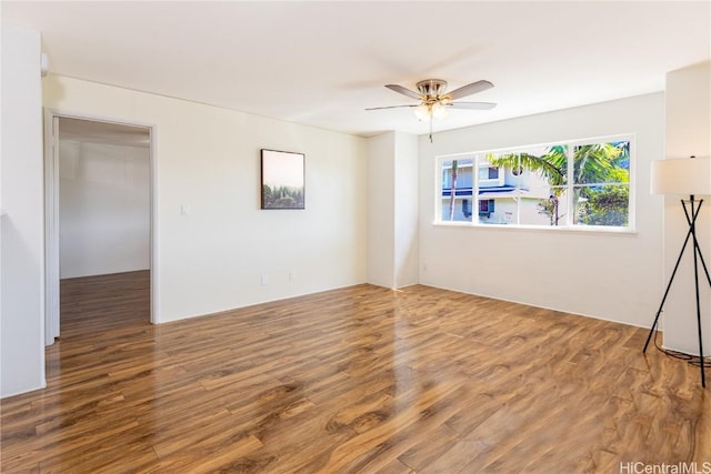 empty room with hardwood / wood-style floors and ceiling fan