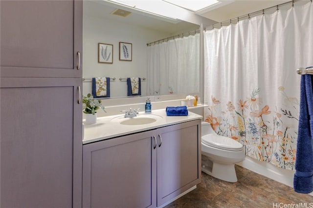 full bathroom featuring shower / bath combination with curtain, vanity, and toilet