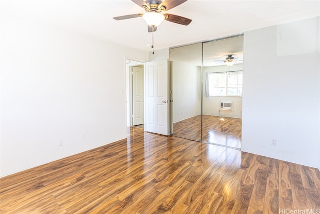 unfurnished bedroom featuring ceiling fan, wood-type flooring, and a closet