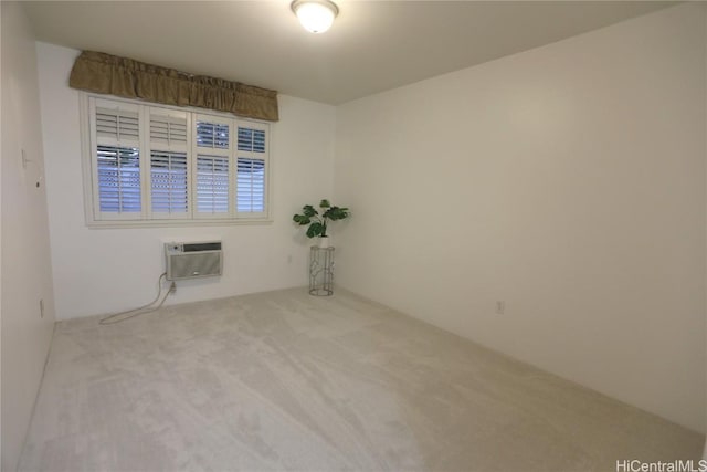 carpeted spare room with a wall unit AC