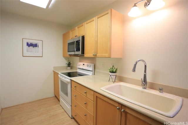 kitchen featuring sink, white electric stove, light hardwood / wood-style floors, and light brown cabinets