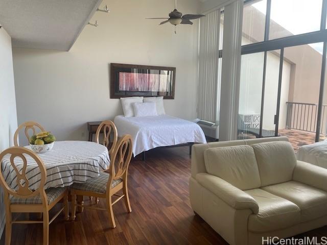 bedroom featuring multiple windows and dark hardwood / wood-style floors