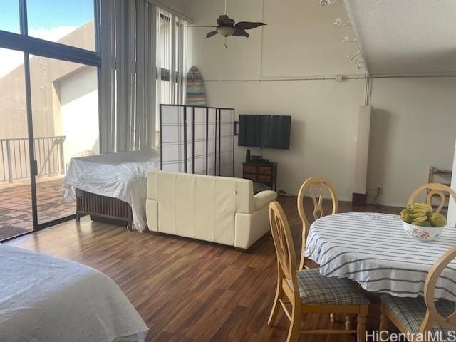 interior space with ceiling fan, dark hardwood / wood-style floors, and a wealth of natural light