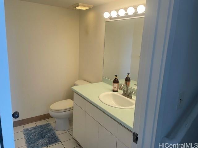 bathroom featuring tile patterned flooring, vanity, and toilet