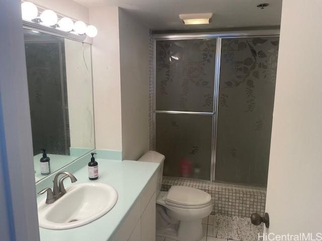 bathroom with vanity, an enclosed shower, tile patterned floors, and toilet