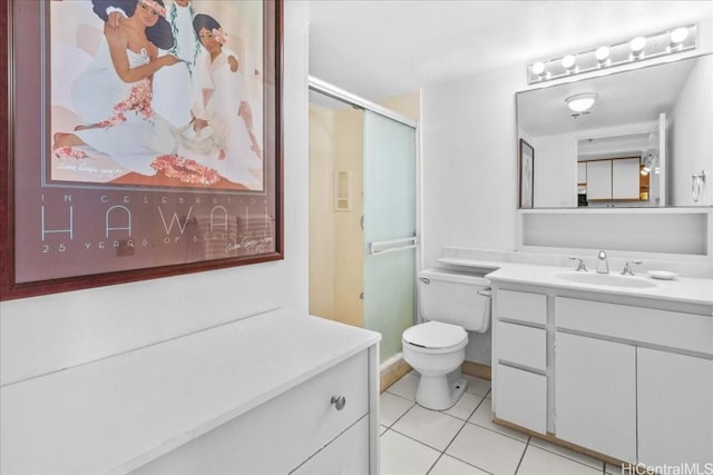 bathroom with vanity, a shower with shower door, tile patterned floors, and toilet