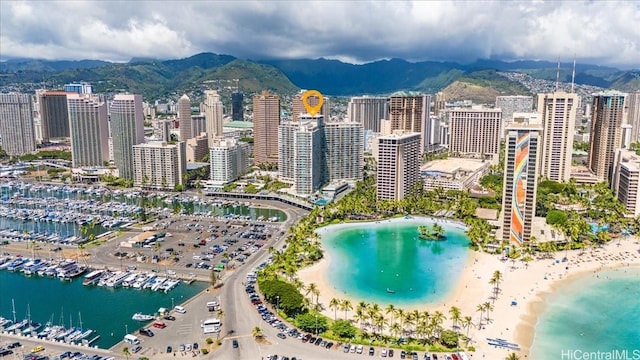 bird's eye view featuring a view of the beach and a water and mountain view