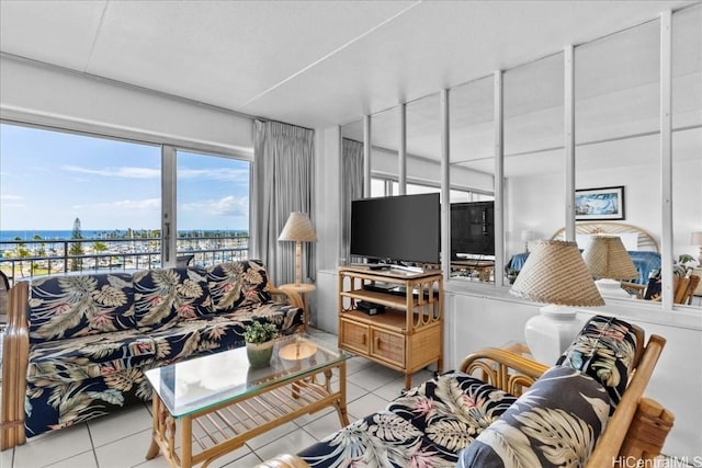 tiled living room featuring a water view