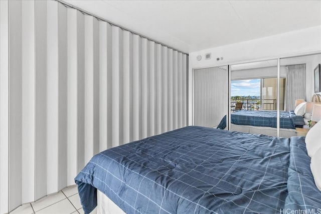 bedroom featuring light tile patterned flooring and access to outside