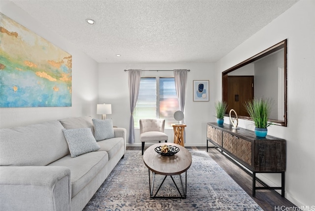 living room featuring dark hardwood / wood-style floors and a textured ceiling