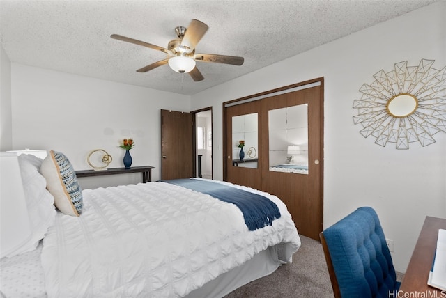 bedroom featuring ceiling fan, carpet floors, and a textured ceiling