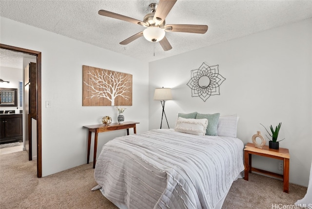 bedroom featuring light carpet, ceiling fan, and a textured ceiling