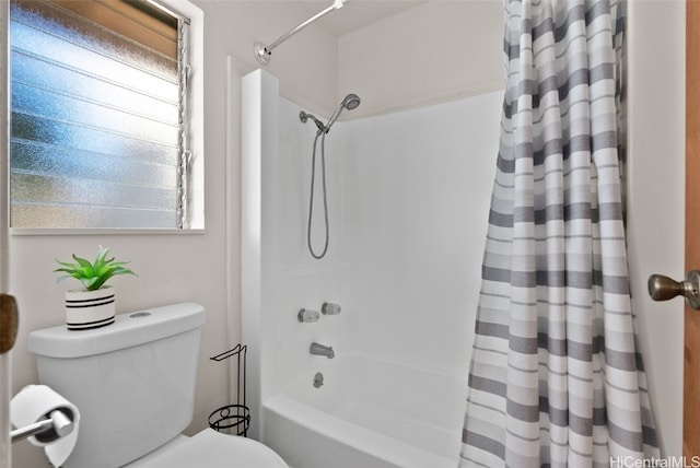 bathroom featuring shower / tub combo with curtain and toilet