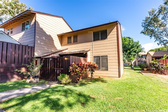 rear view of property with a lawn