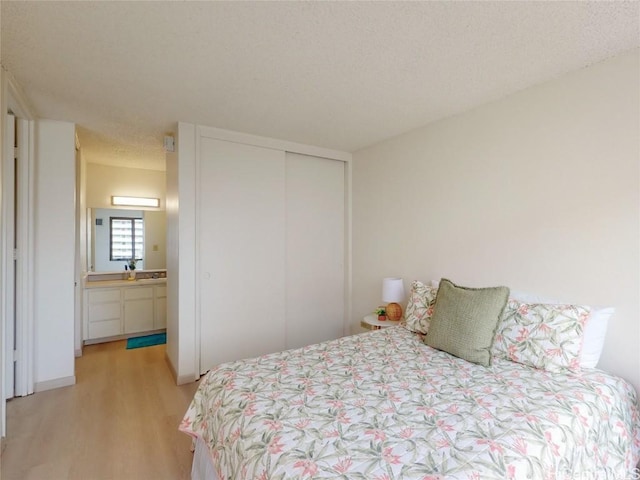 bedroom featuring light hardwood / wood-style floors and a closet