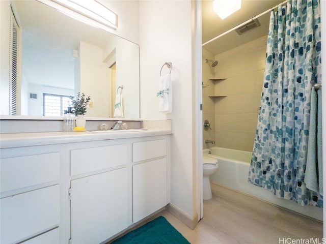 full bathroom with shower / bathtub combination with curtain, vanity, and toilet