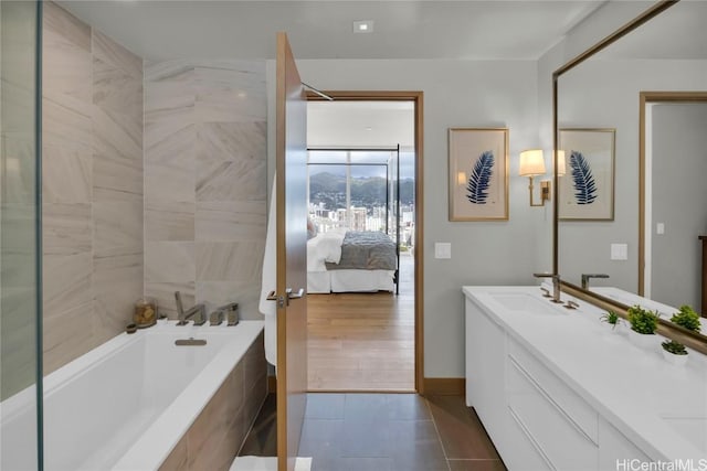 888 Kapiolani Blvd Unit Ph4501, Honolulu, HI 96813 - full bathroom featuring baseboards, ensuite bathroom, tile patterned flooring, vanity, and tiled tub