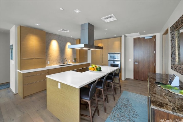 888 Kapiolani Blvd Unit Ph4501, Honolulu, HI 96813 - kitchen with a sink, modern cabinets, a kitchen island, and island range hood
