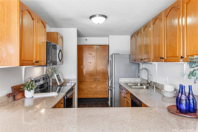 kitchen with sink, dark tile patterned flooring, a textured ceiling, and black appliances