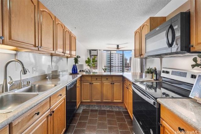 kitchen featuring sink, ceiling fan, black appliances, a textured ceiling, and kitchen peninsula