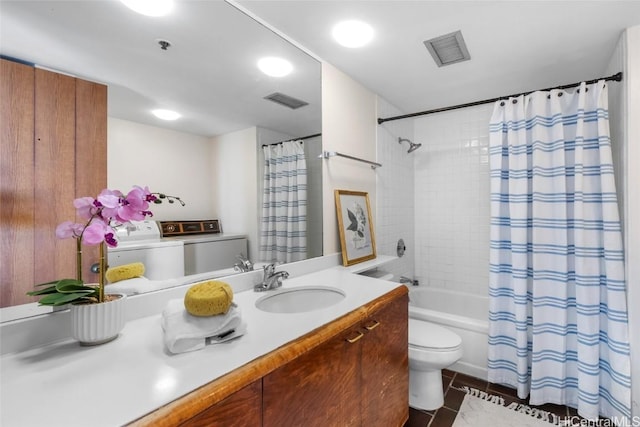 full bathroom with tile patterned floors, toilet, washer and dryer, vanity, and shower / bath combination with curtain