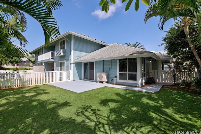 back of house with a balcony, a patio area, and a lawn