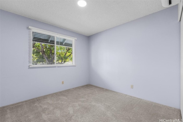 carpeted spare room featuring a textured ceiling