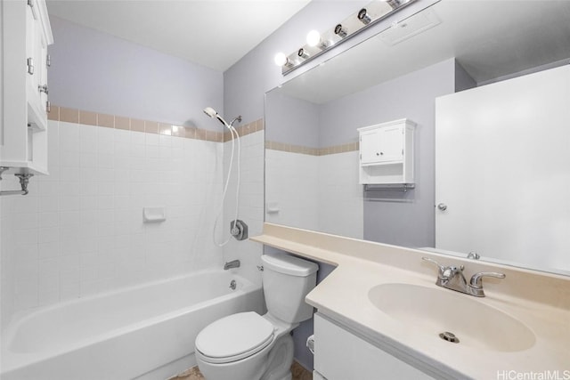 full bathroom with vanity, tiled shower / bath combo, and toilet