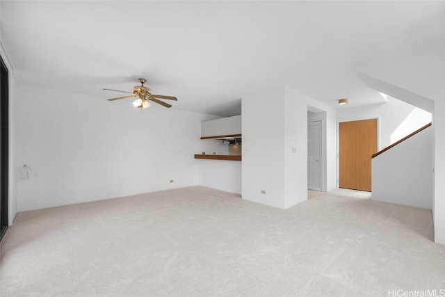 unfurnished living room with ceiling fan and light colored carpet