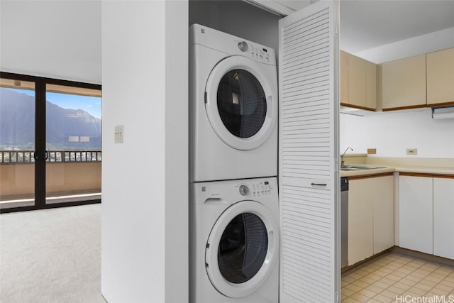 washroom featuring a mountain view, sink, and stacked washer / dryer