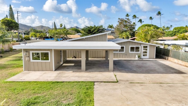 garage with a carport, a yard, and a mountain view