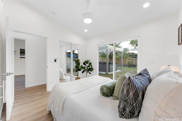 bedroom with lofted ceiling, ceiling fan, access to outside, a closet, and light wood-type flooring