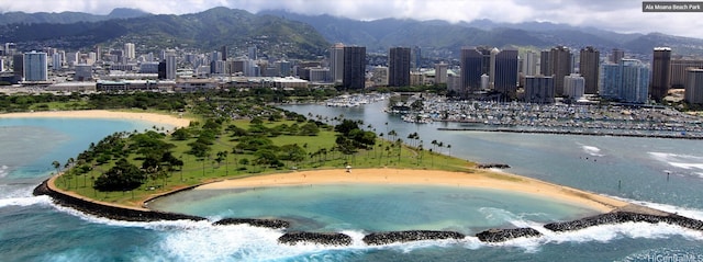 exterior space with a water and mountain view and a view of the beach